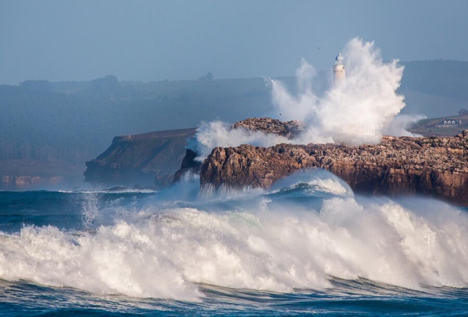 Huge waves hit the rocks of the coast displaying rising sea levels