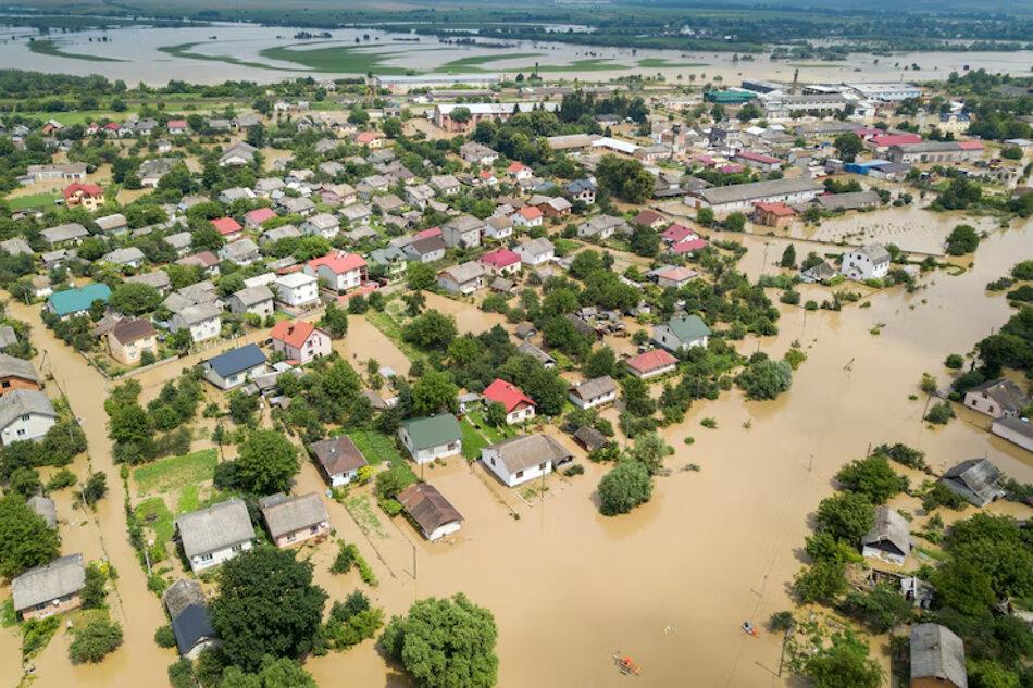 An aerial photograph of a small town which has been flooded following heavy rains