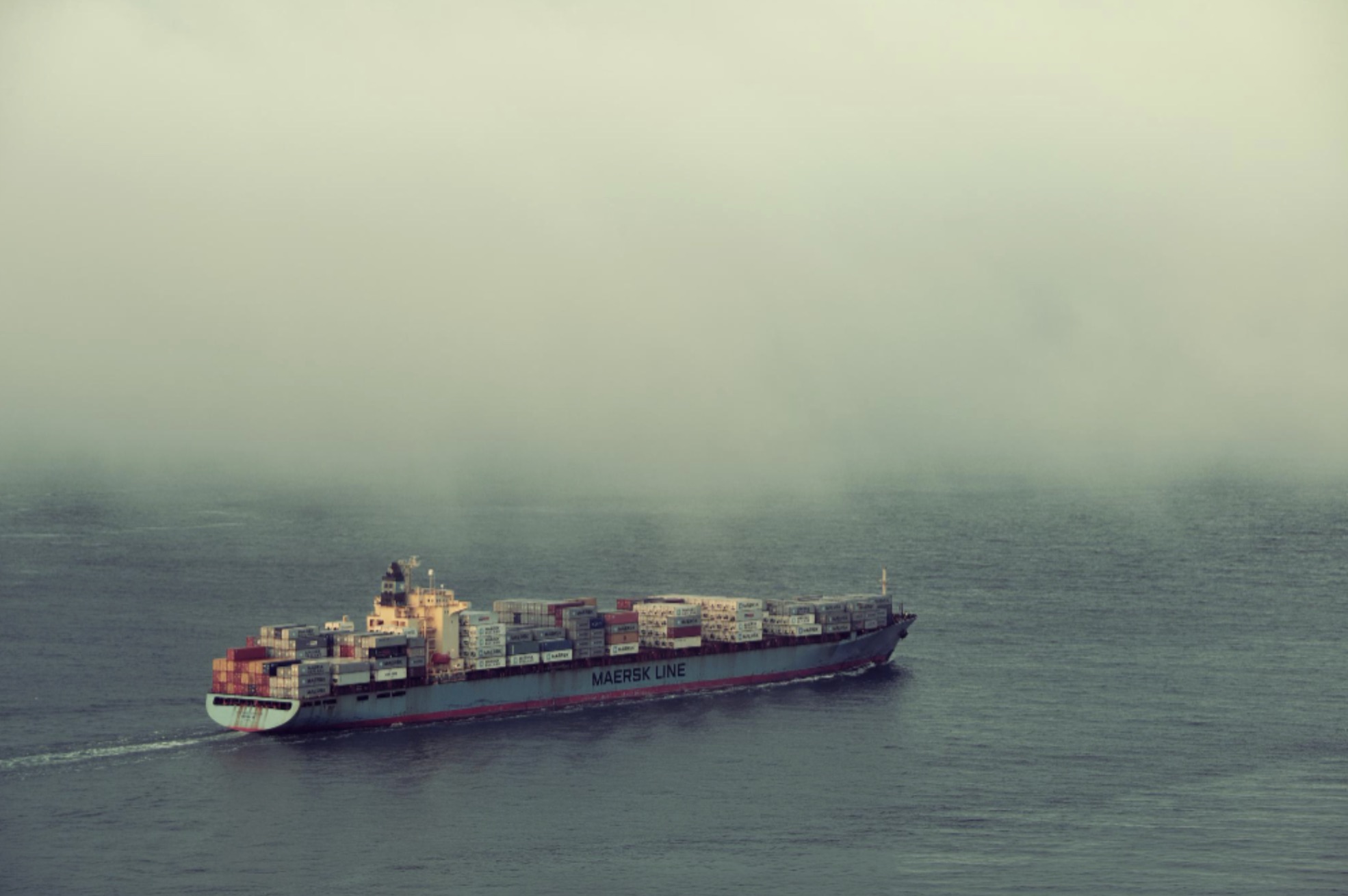 A large shipping container is pictured at sea