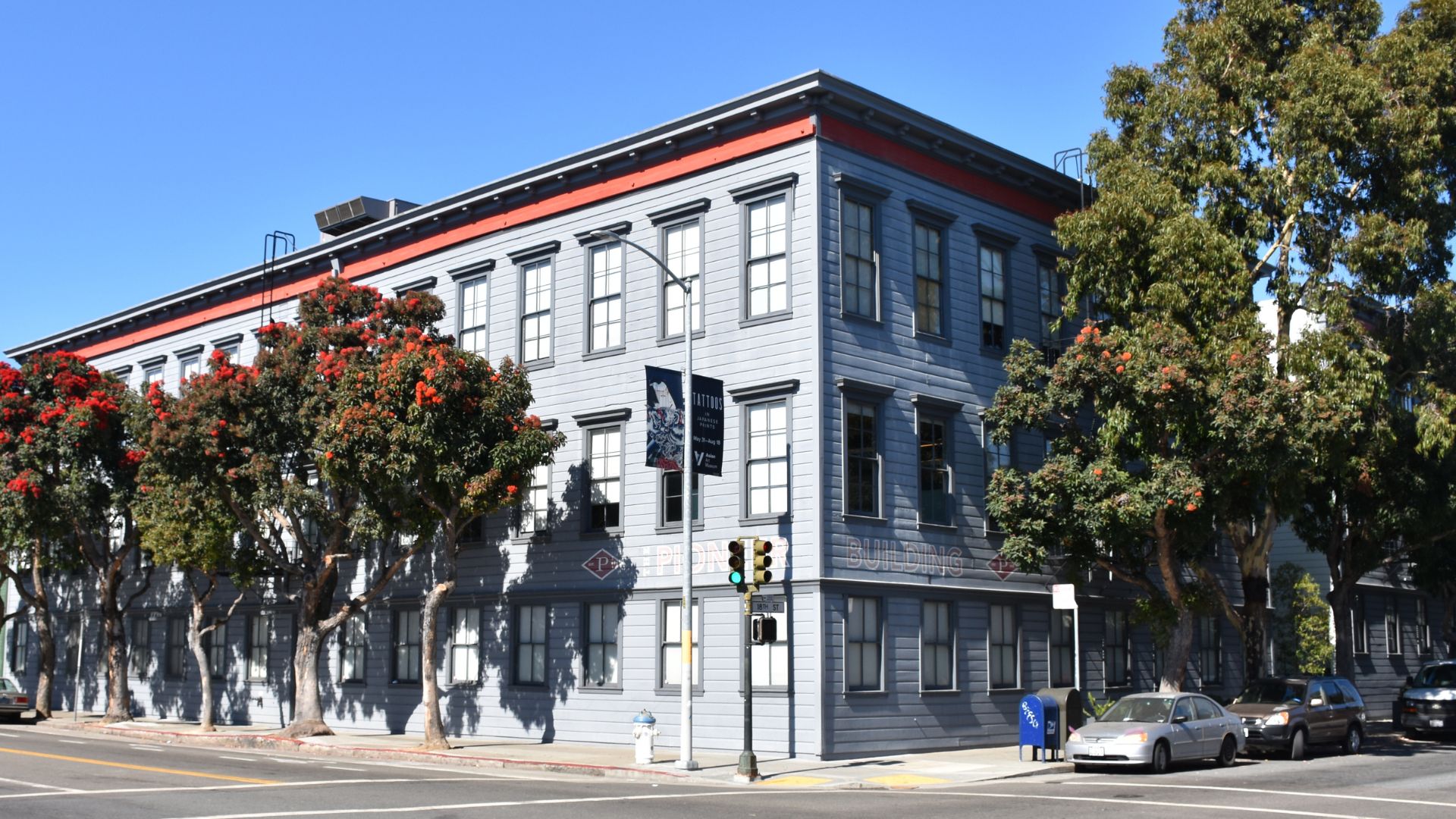 The Pioneer Building, which houses Neuralink and OpenAI, seen in San Francisco with cars out front of it.