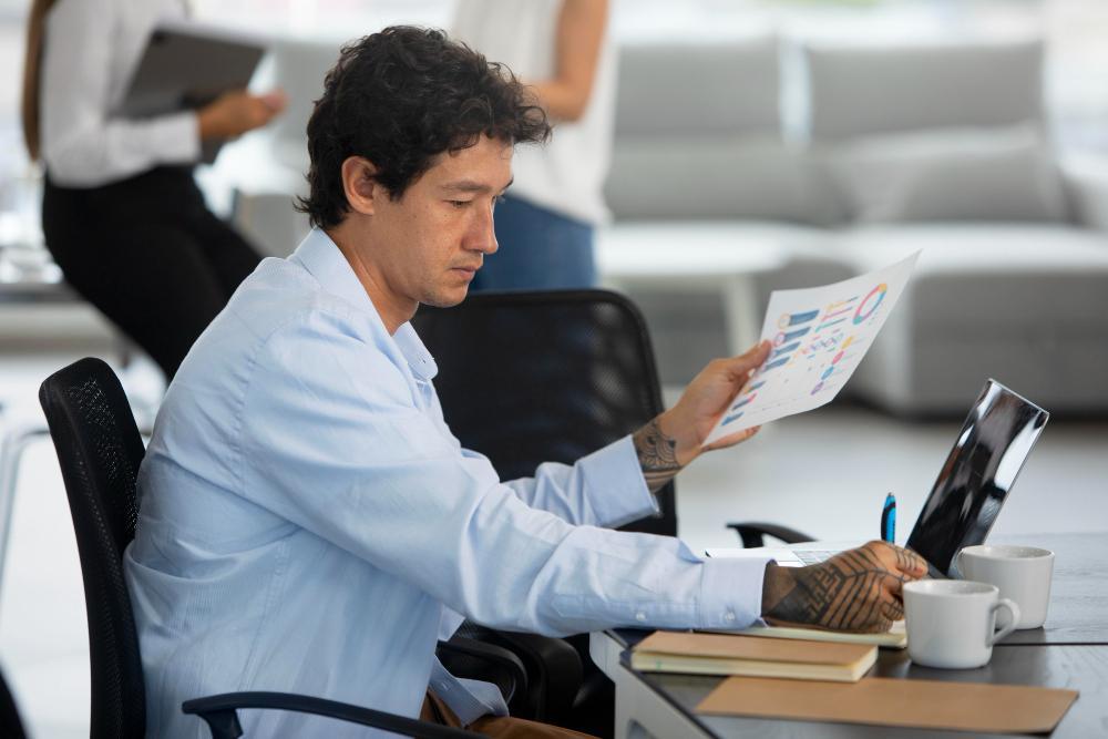 A man is pictured working on a theory at his desk