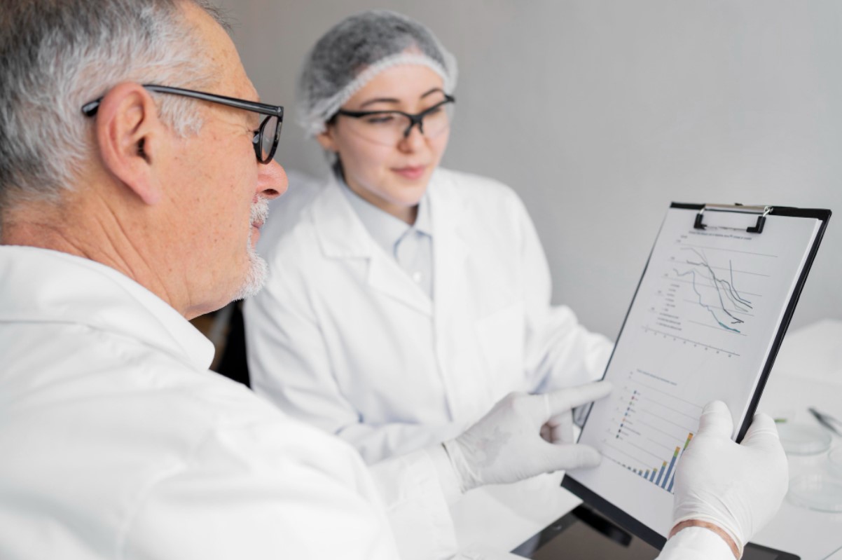 Scientists are pictured looking over data in their lab
