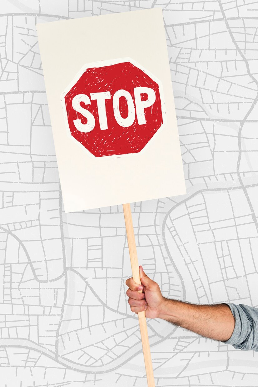Hand holding a stop sign