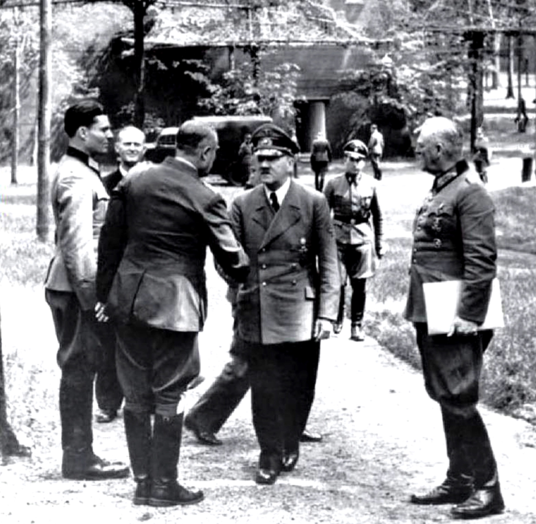 An image of Adolf Hitler meeting with several people at the Wolf’s Lair in Poland