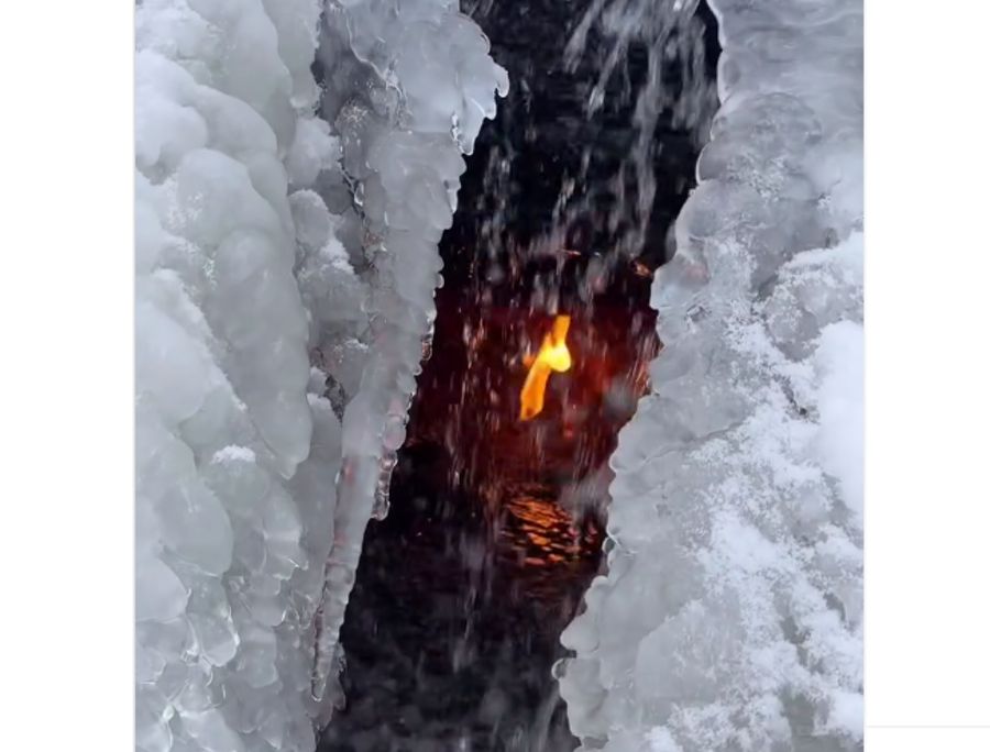 A photograph of a flame in a cave