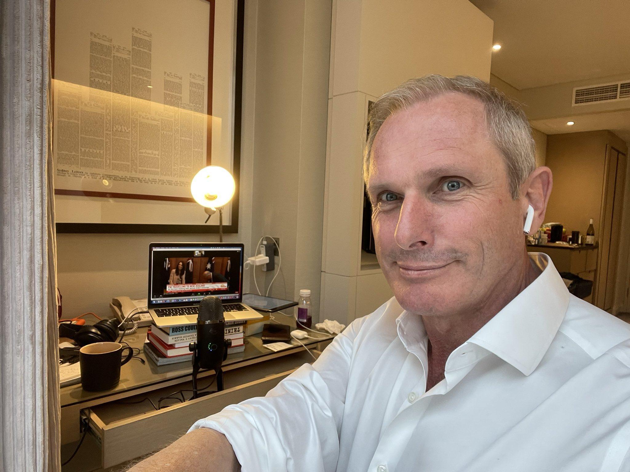 A photograph of Ross Coulthart in a hotel room