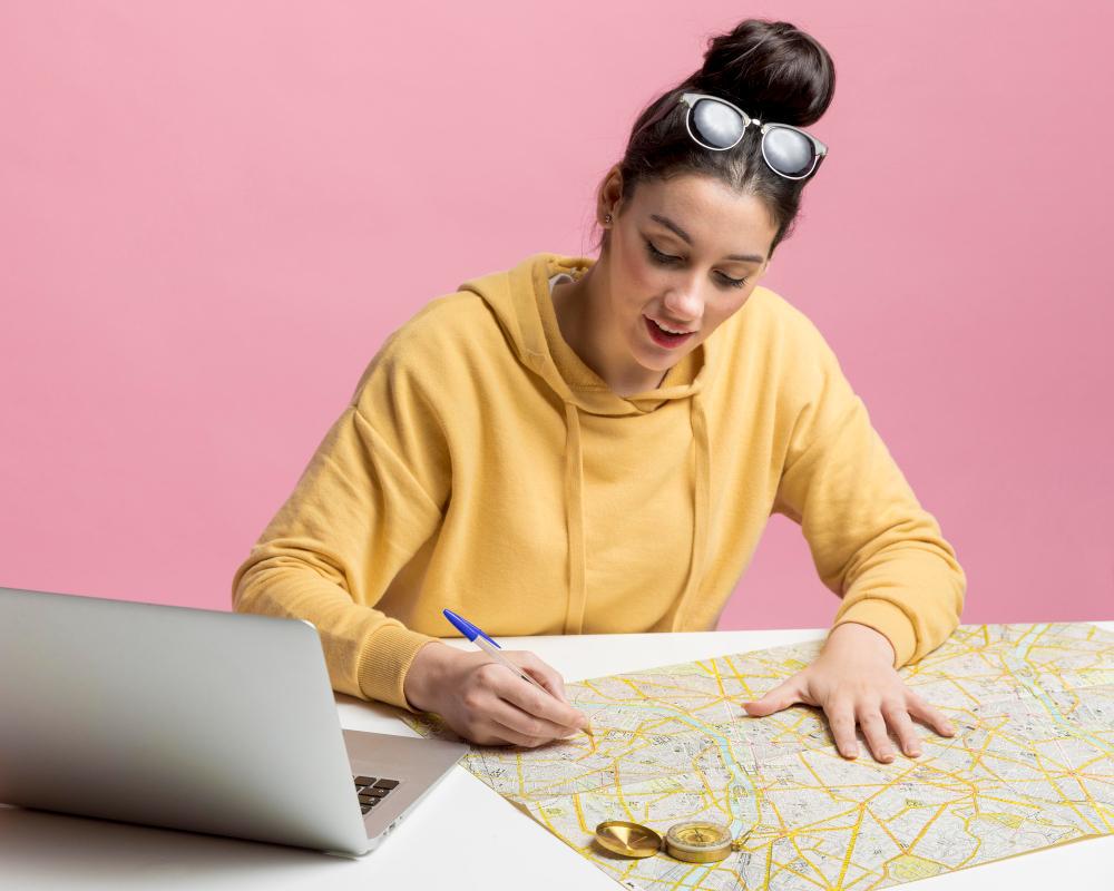 A woman is pictured working on a map