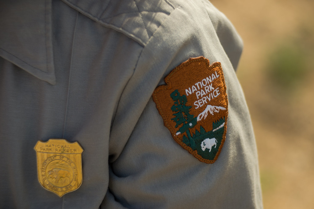 A close up of a National Park Services badge ona active ranger