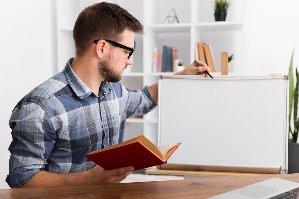 A photograph of a man reading a book