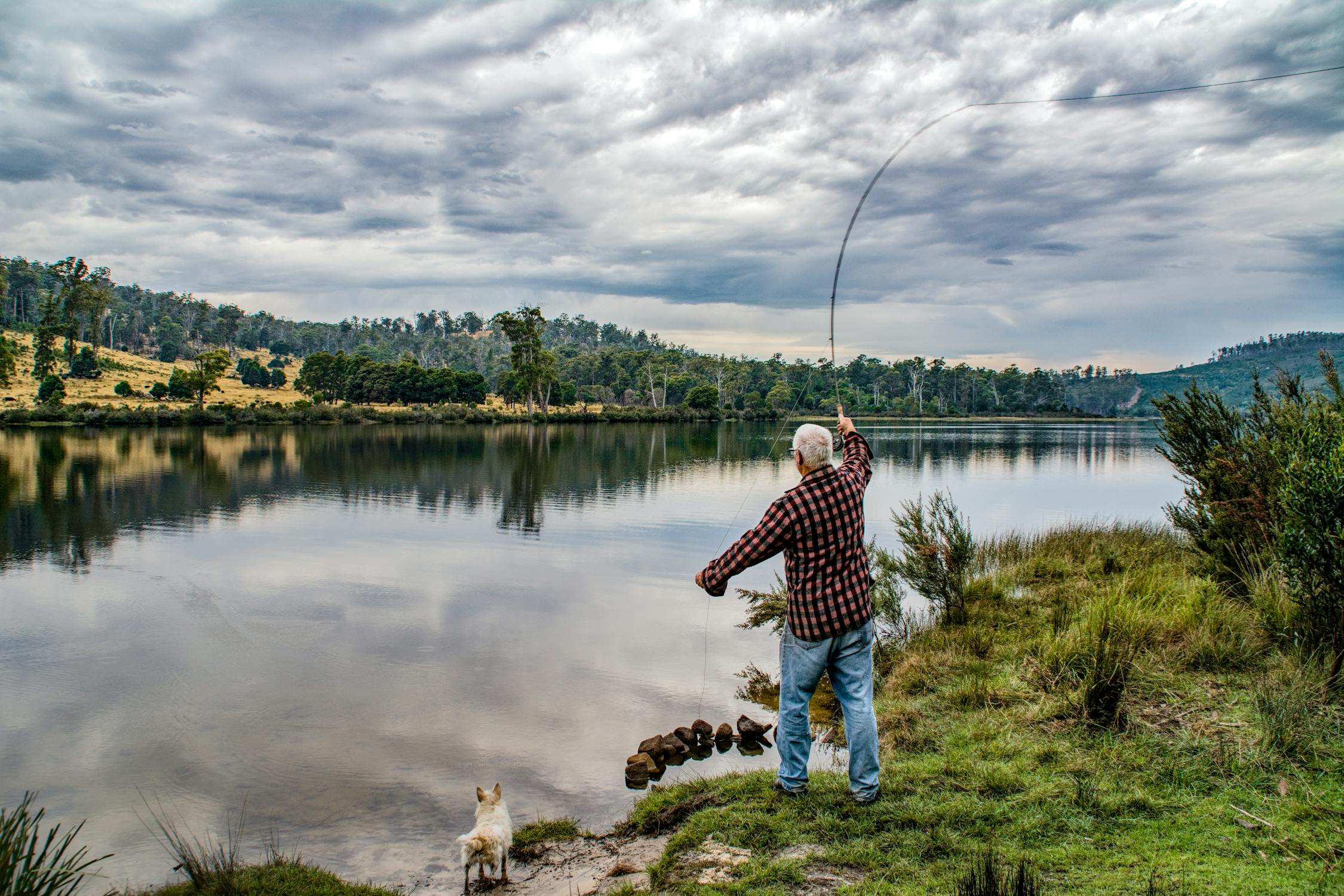 A person casting a line into the water
