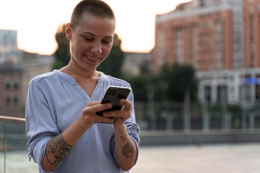 A photograph of a woman using her smartphone