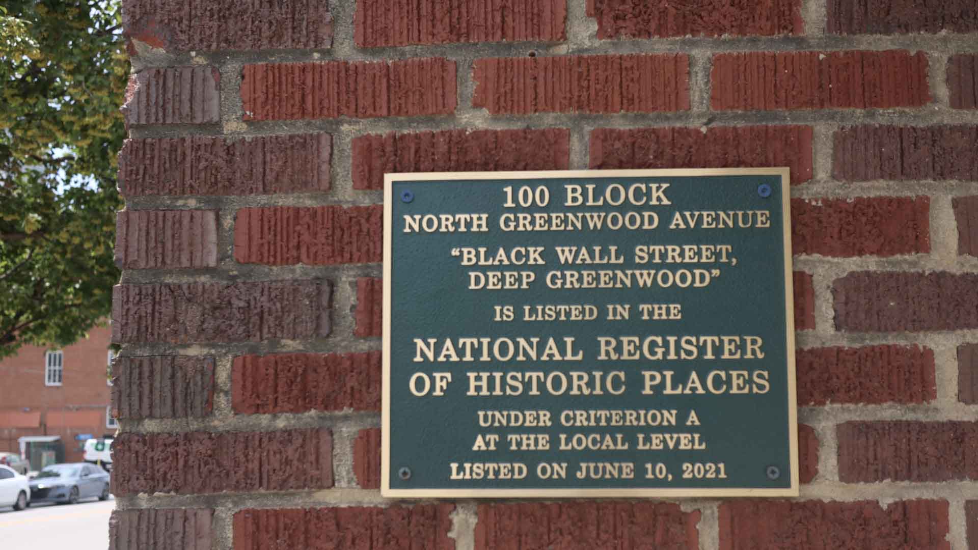 A commemorative plaque in Tulsa's Greenwood district marks the historic location of Black Wall Street.