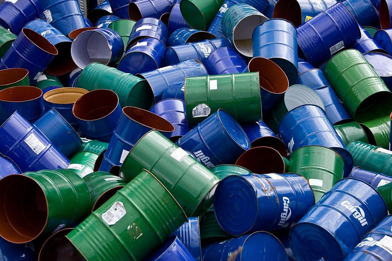 A photograph of numerous empty oil barrels