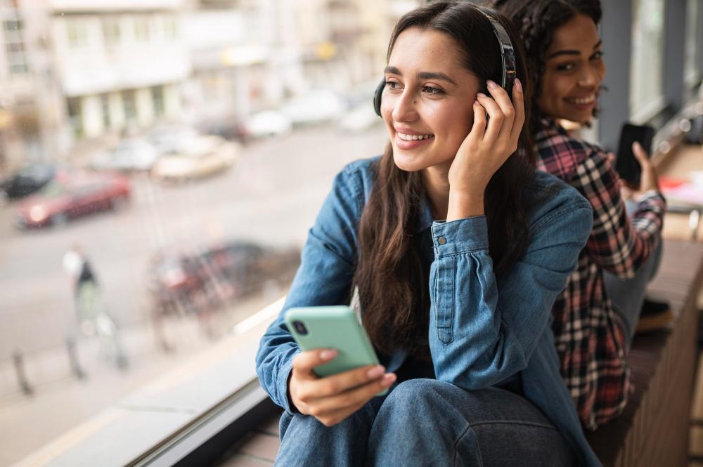 A photograph of a woman listening to music