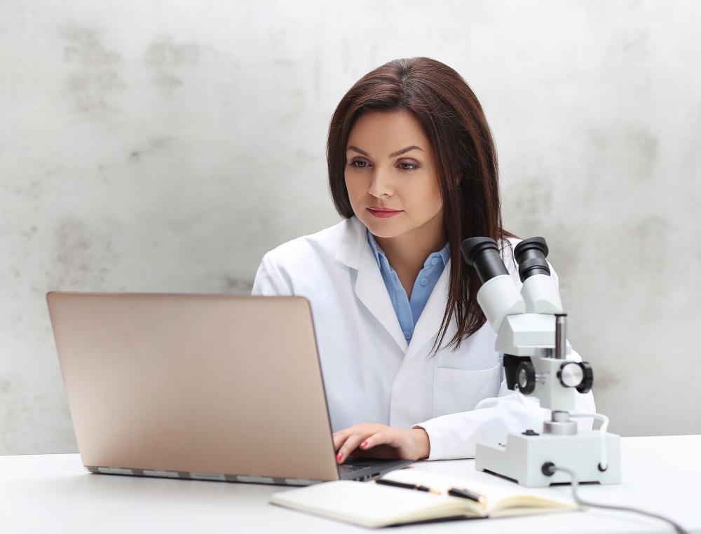 A photograph of a scientist pictured at her desk