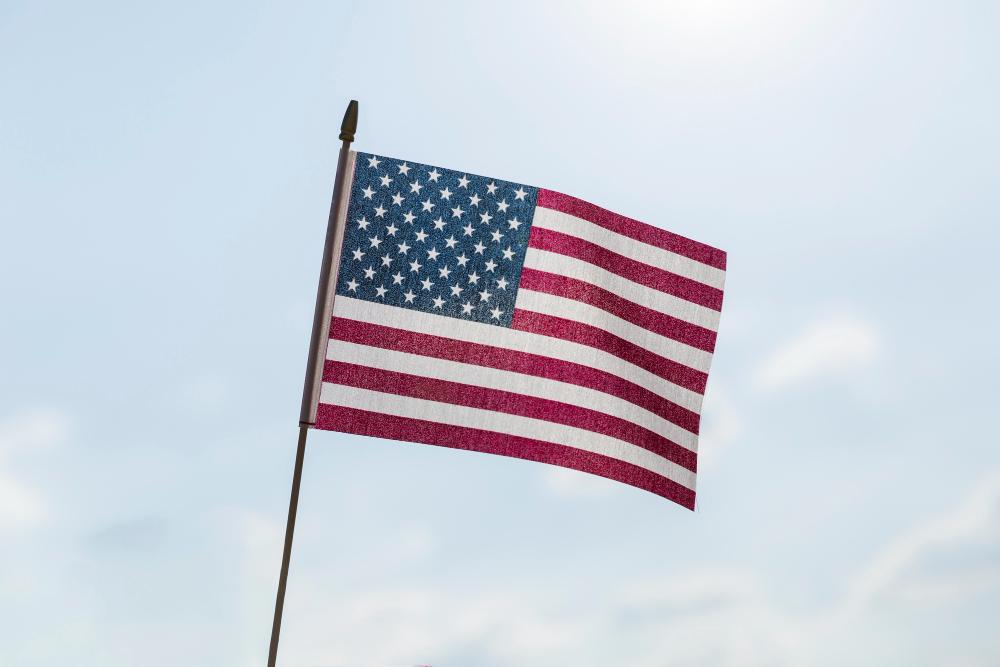 A photograph of an American flag blowing in the wind