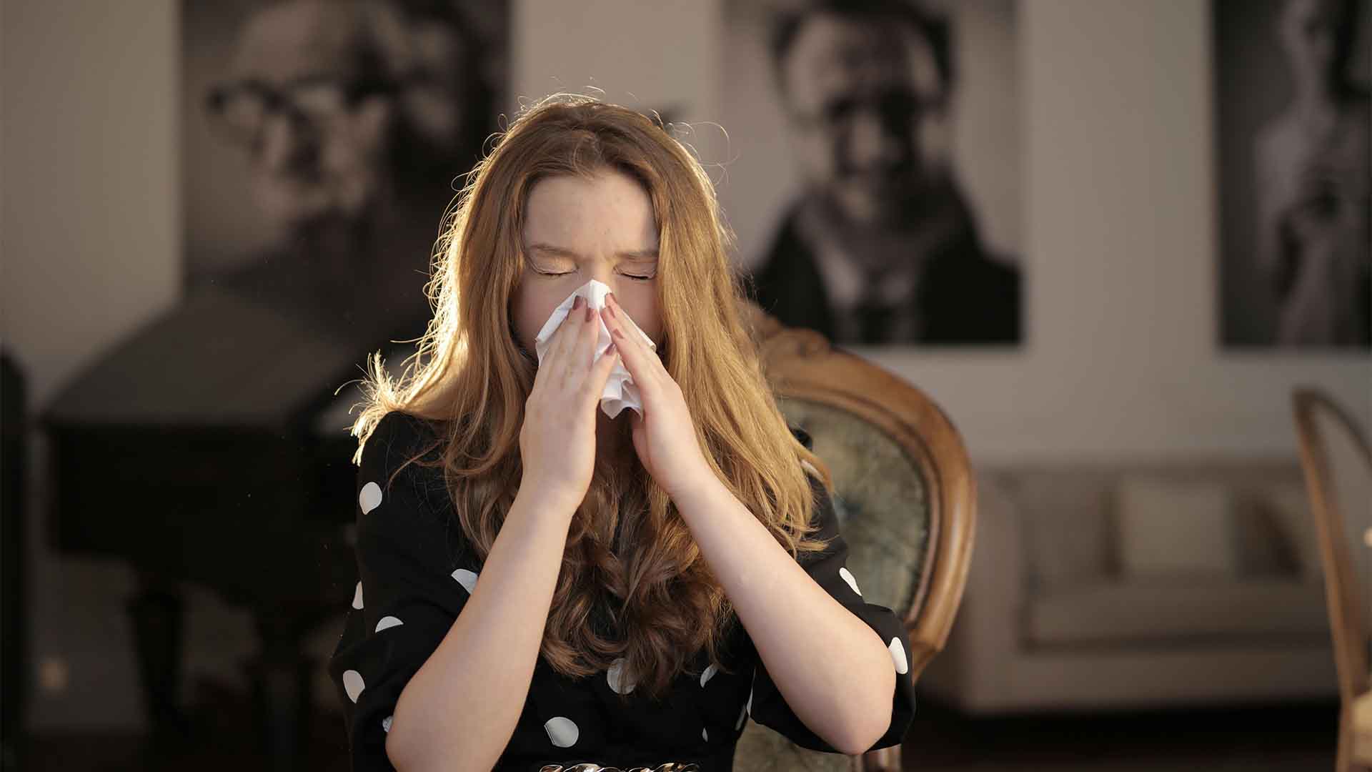 Sick Woman Wiping Her Nose with Tissue