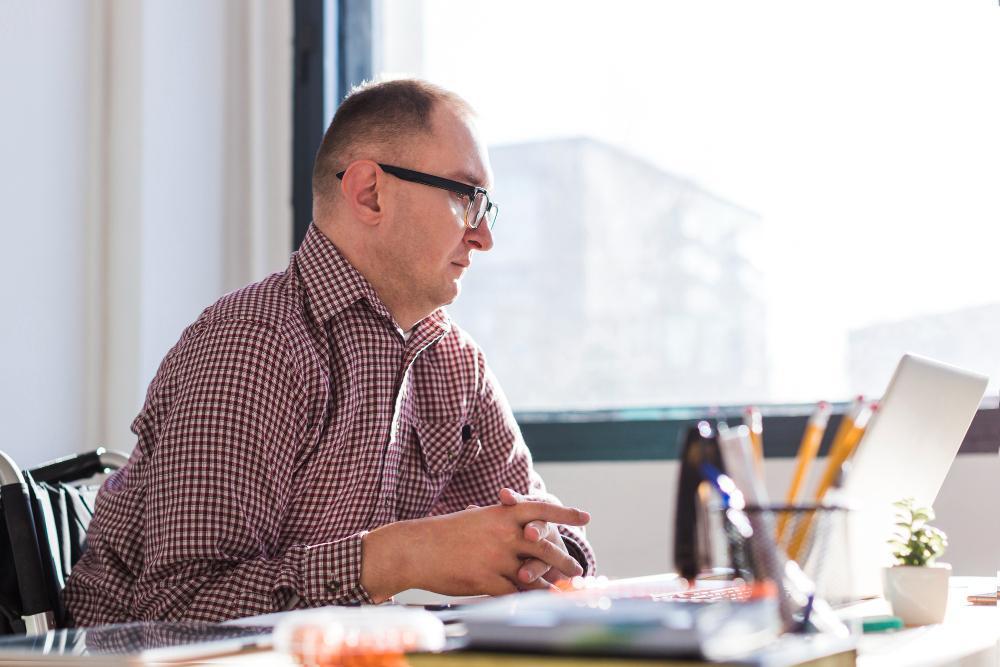 A man is pictured working at his desk