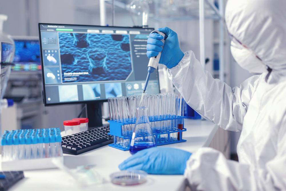 A photograph of a scientist testing samples at his desk