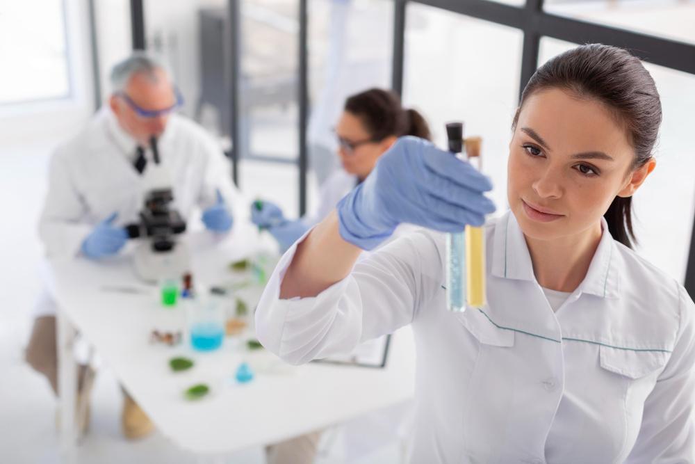 A scientist is pictured with several test samples in her lab