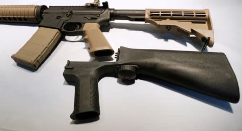 Gun bump stock on table