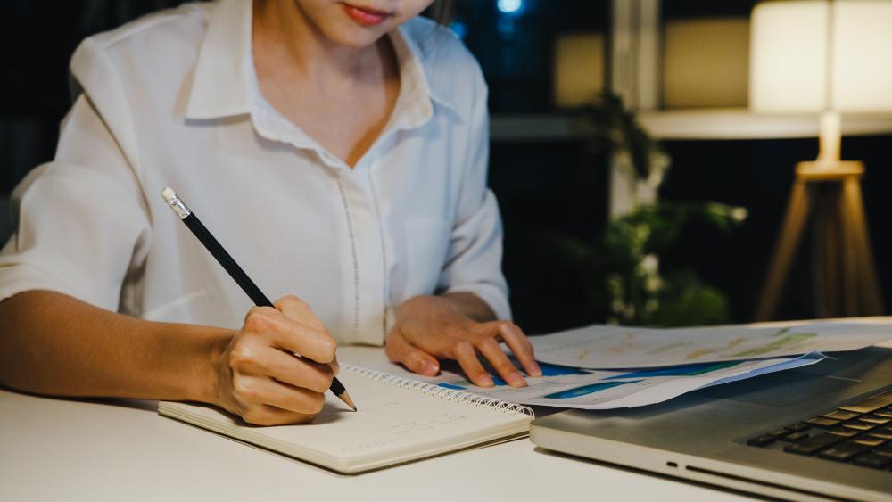 A researcher is pictured seated at her desk