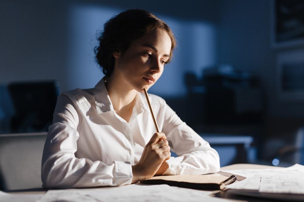 A photograph of a female researcher seated at her desk