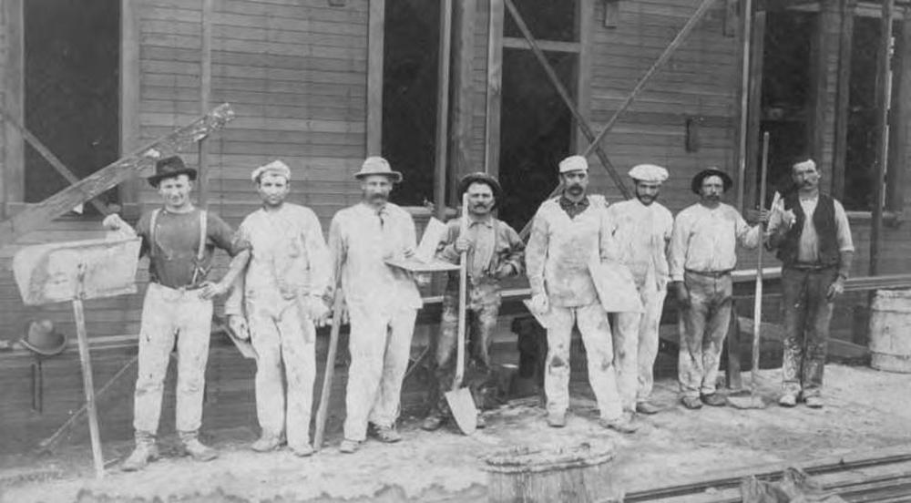 A photograph of several construction workers from the 19th century