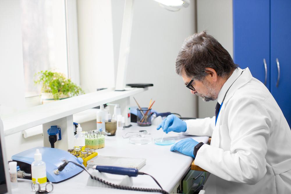 A photograph of a scientist working at his desk