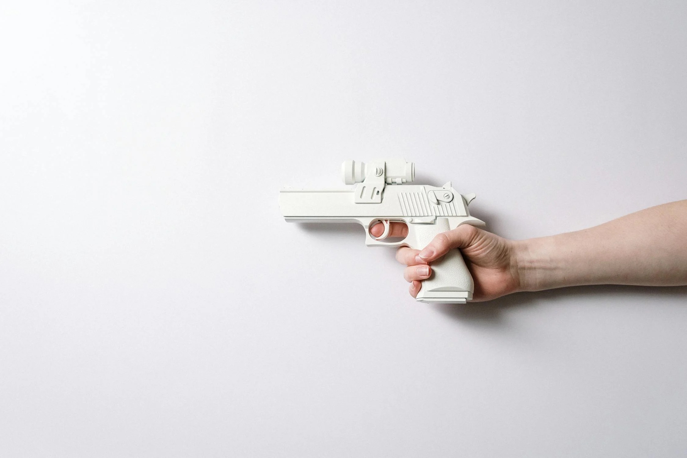 Person Holding White and Gray Toy Gun
