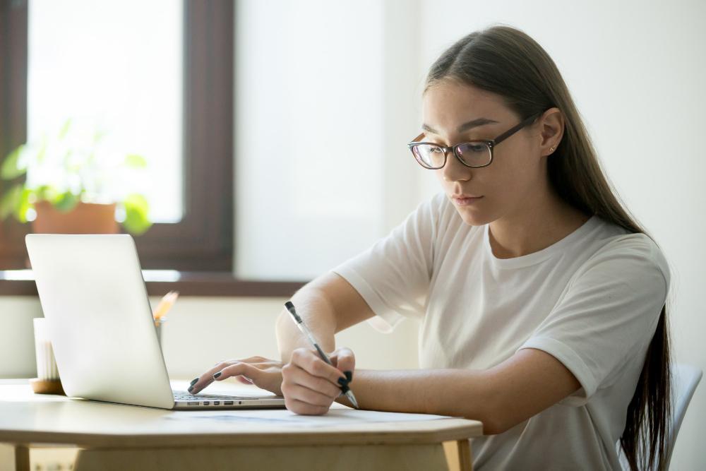 A photograph of a researcher working at her home desk