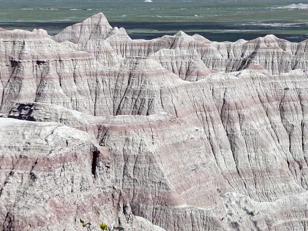 The White River Badlands of South Dakota consist of a scenic landscape of differentially weathered and eroded, nonmarine sedimentary rocks of Tertiary age. The most visually-striking areas have been set aside as an American national park (Badlands).