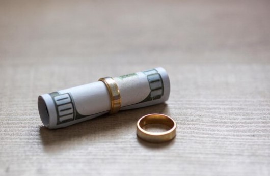 Hundred dollar bill rolled up and put inside a ring wit another ring on the side