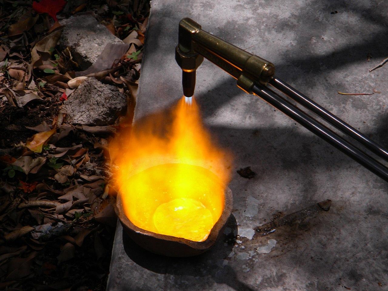 A photograph of someone smelting copper