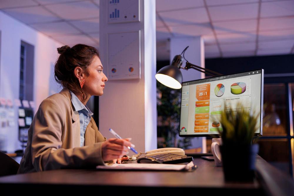 A photograph of a researcher seated at her desk