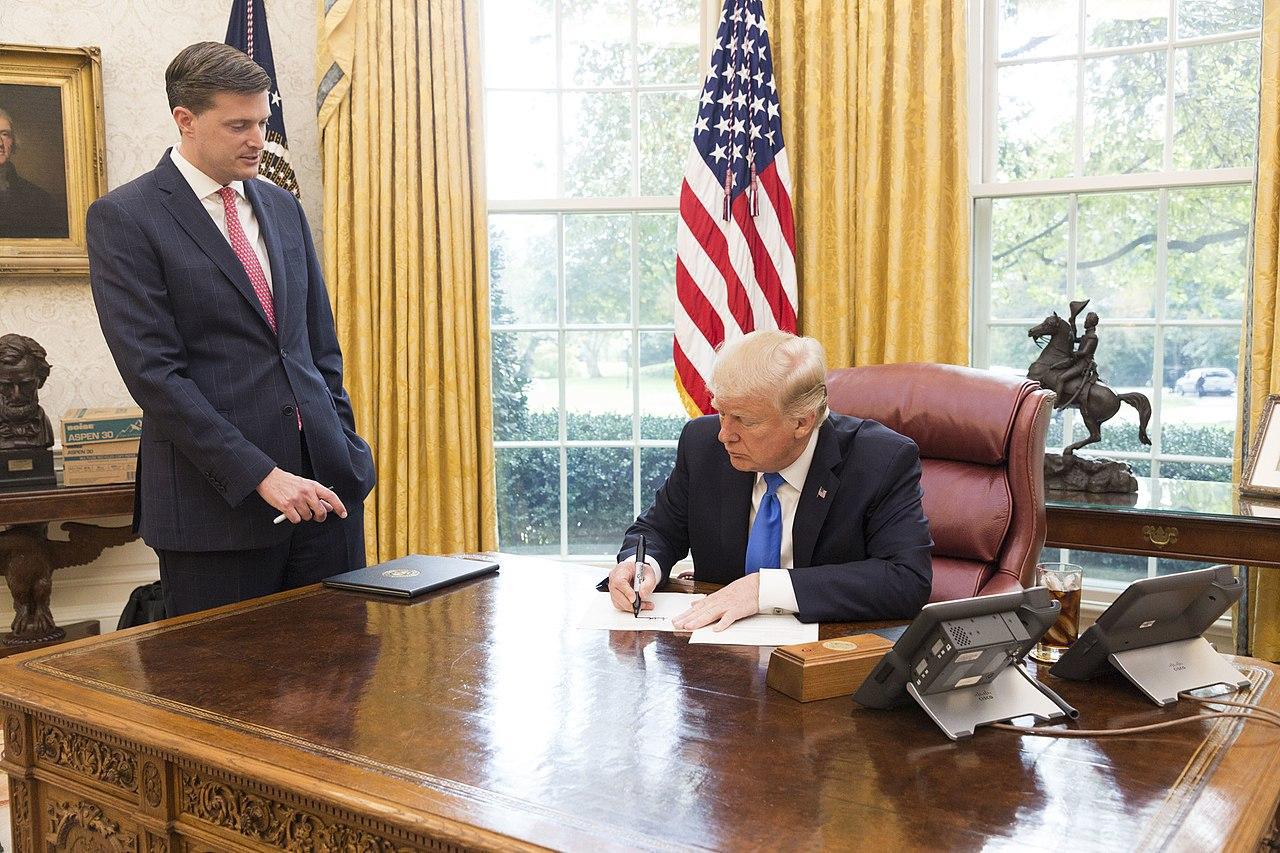 A photograph of Donald Trump seated in the Oval Office