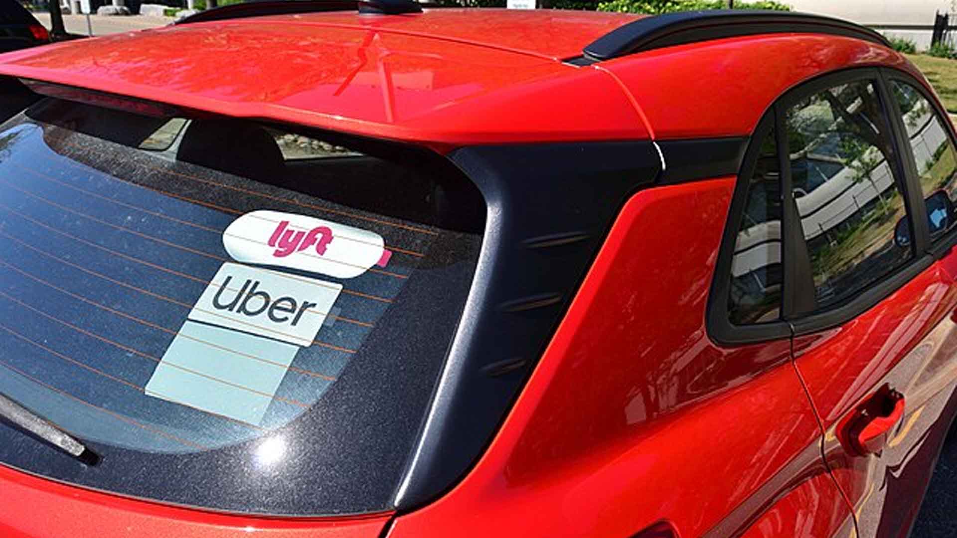 Uber Lyft decals seen on red car