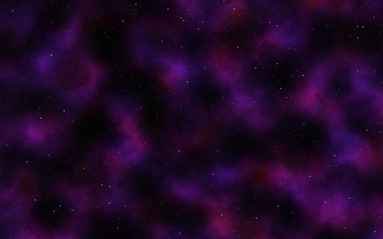 A photograph of deep space with black, purple, and pink