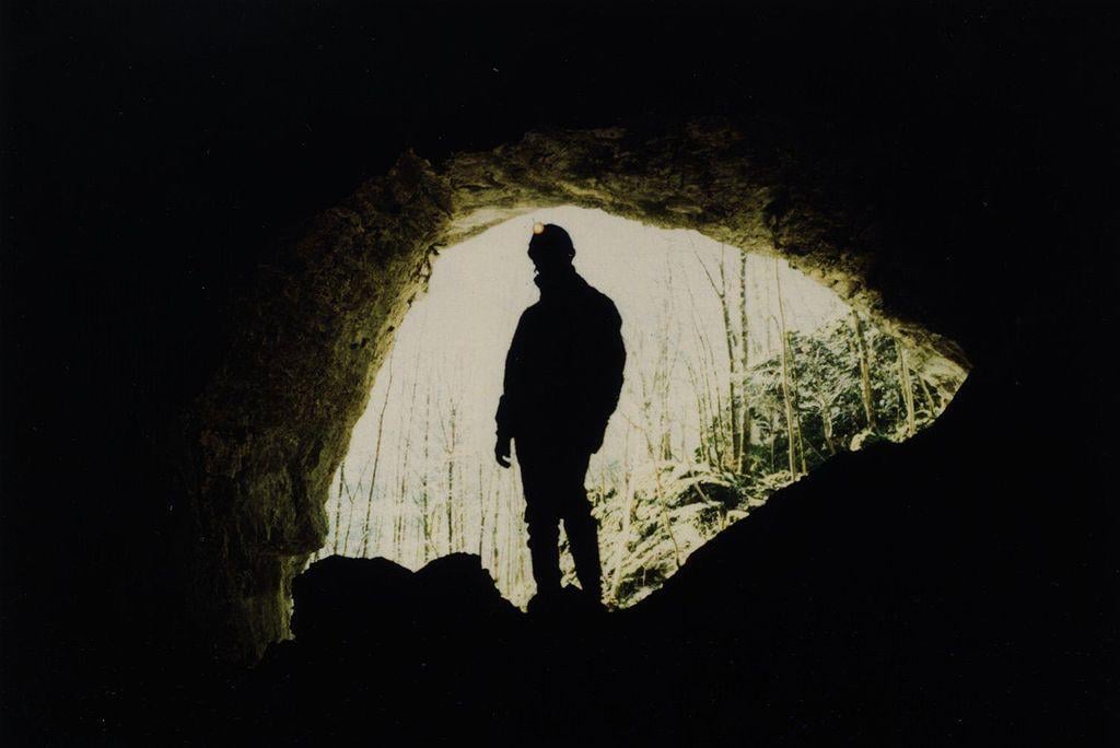 A photograph of a researcher working in a cave