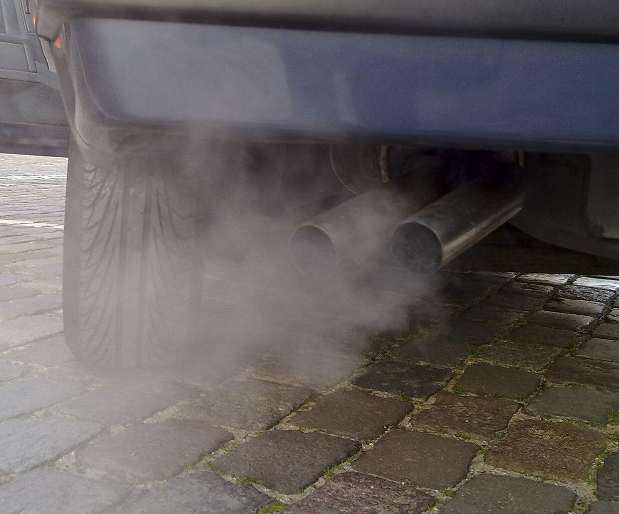 A photograph of a car emitting smoke