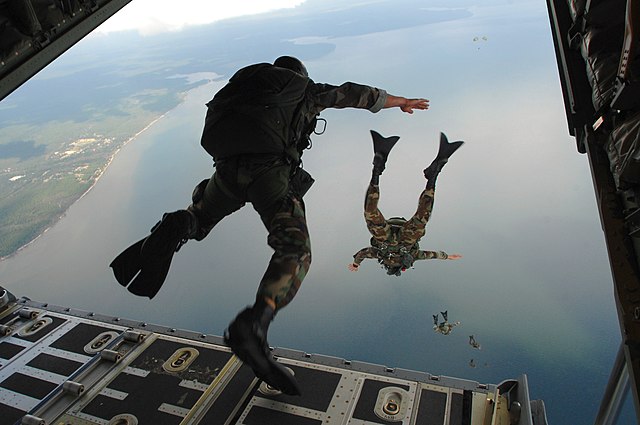 Airmen jumping out of a flying plane