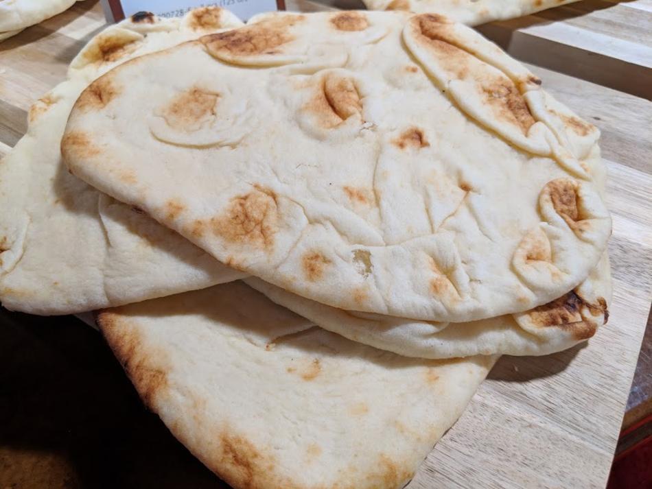 A photograph of naan flatbread pictured on a table