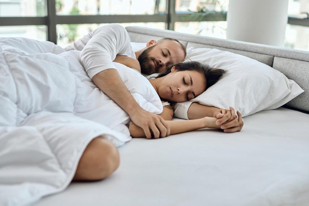 A photograph of a man and woman napping