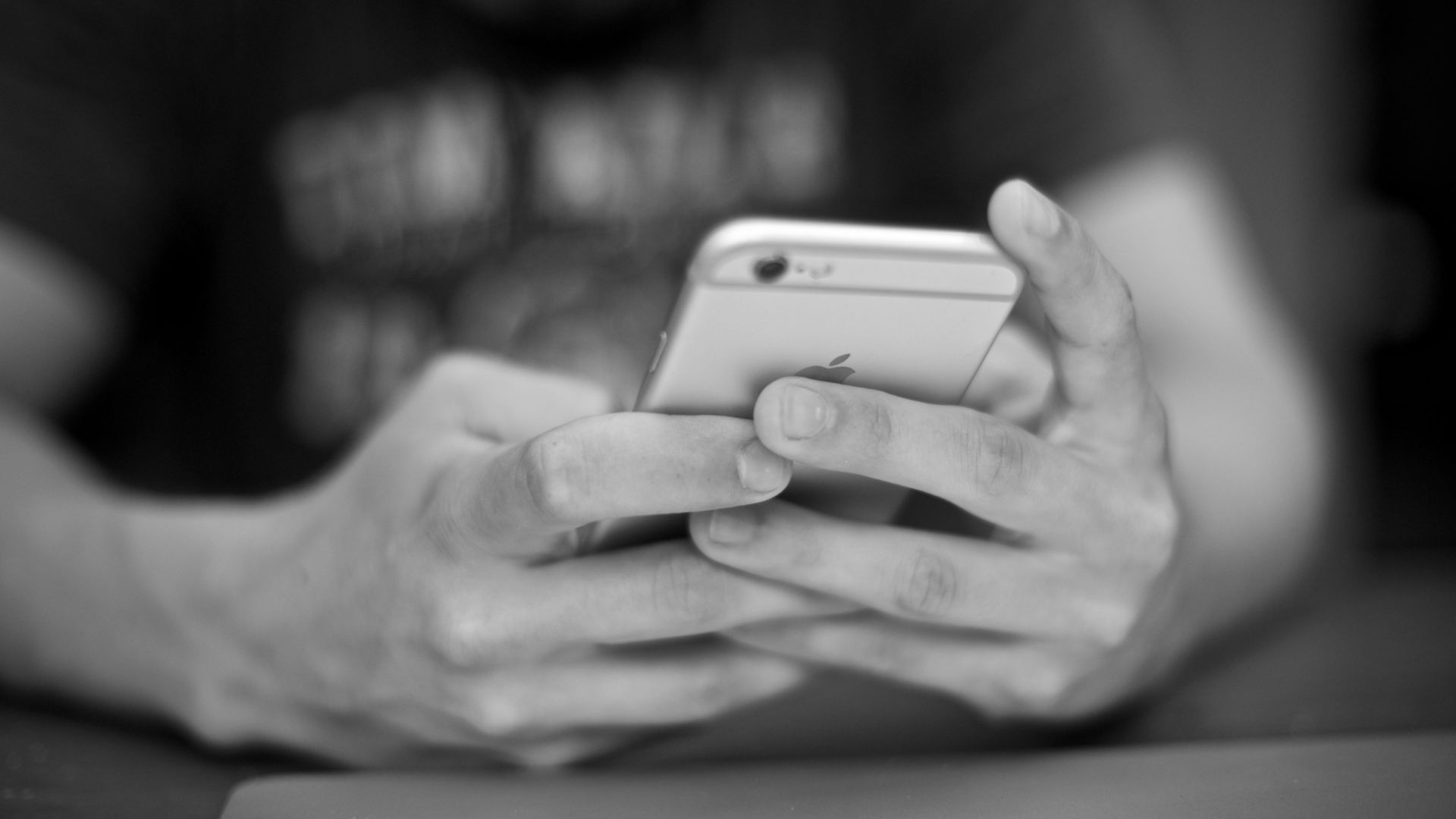 A man typing on an iPhone