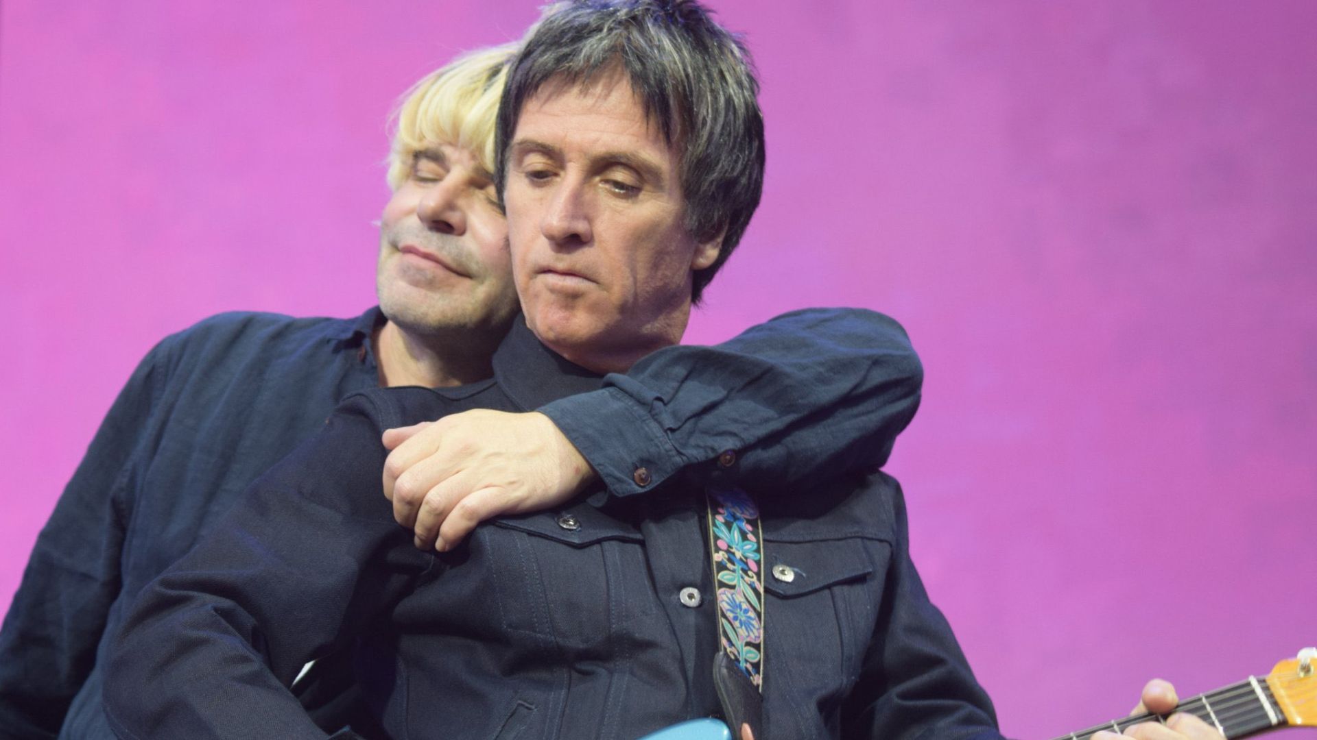 Johnny Marr and Tim Burgess performing on stage