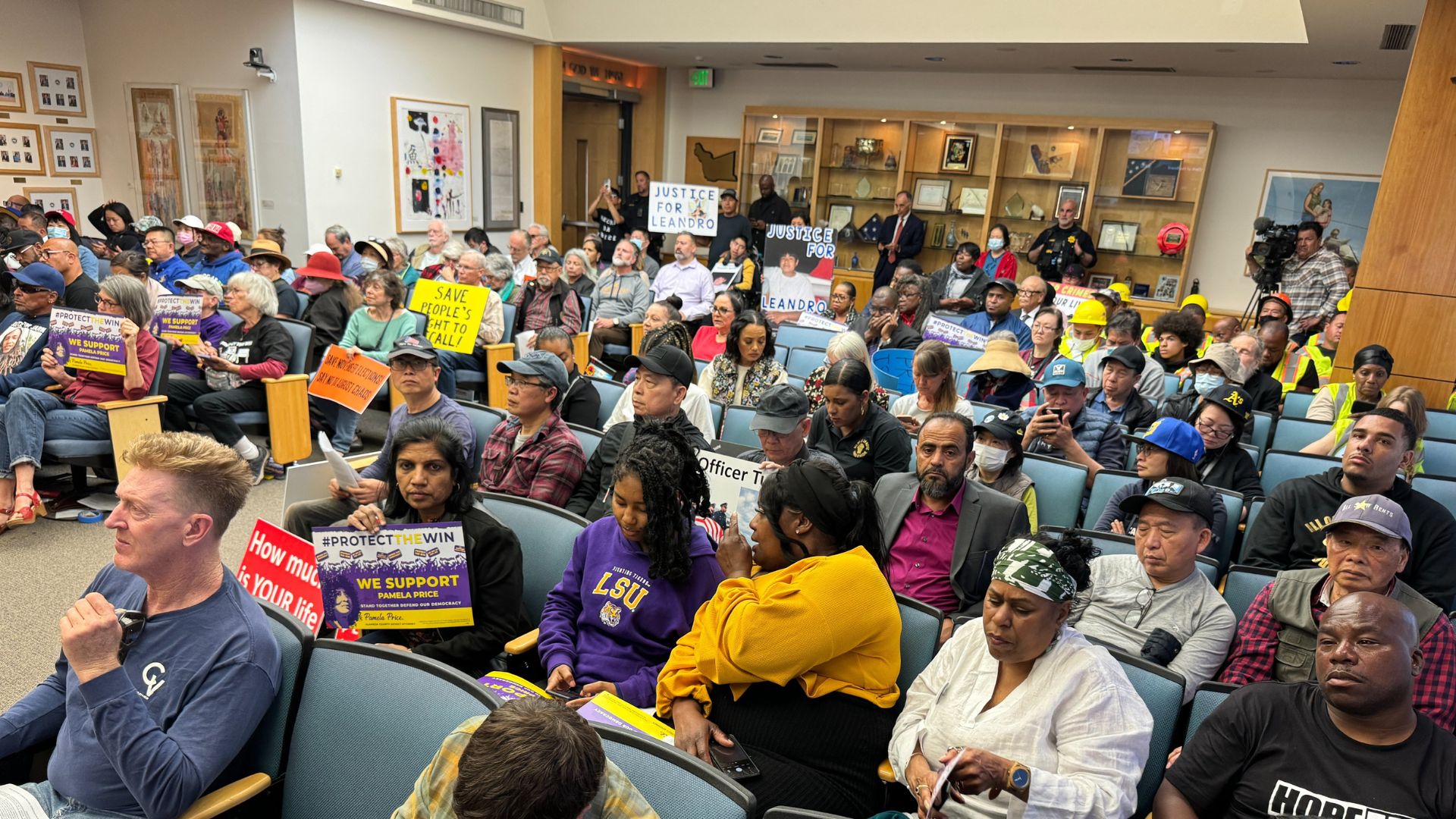 A large room of people waiting for a recall election meeting in Berkeley, CA