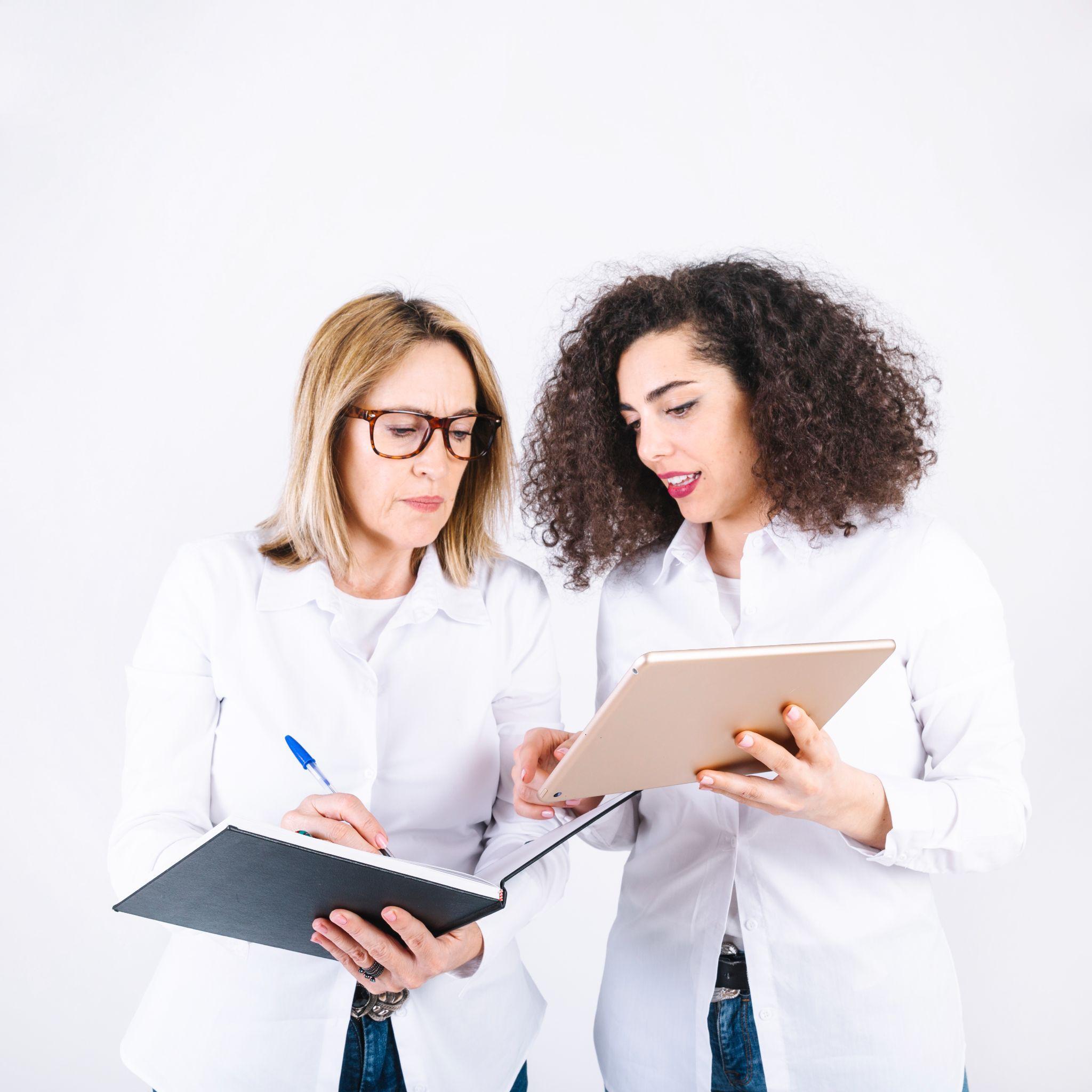 A photograph of two scientists checking over test results