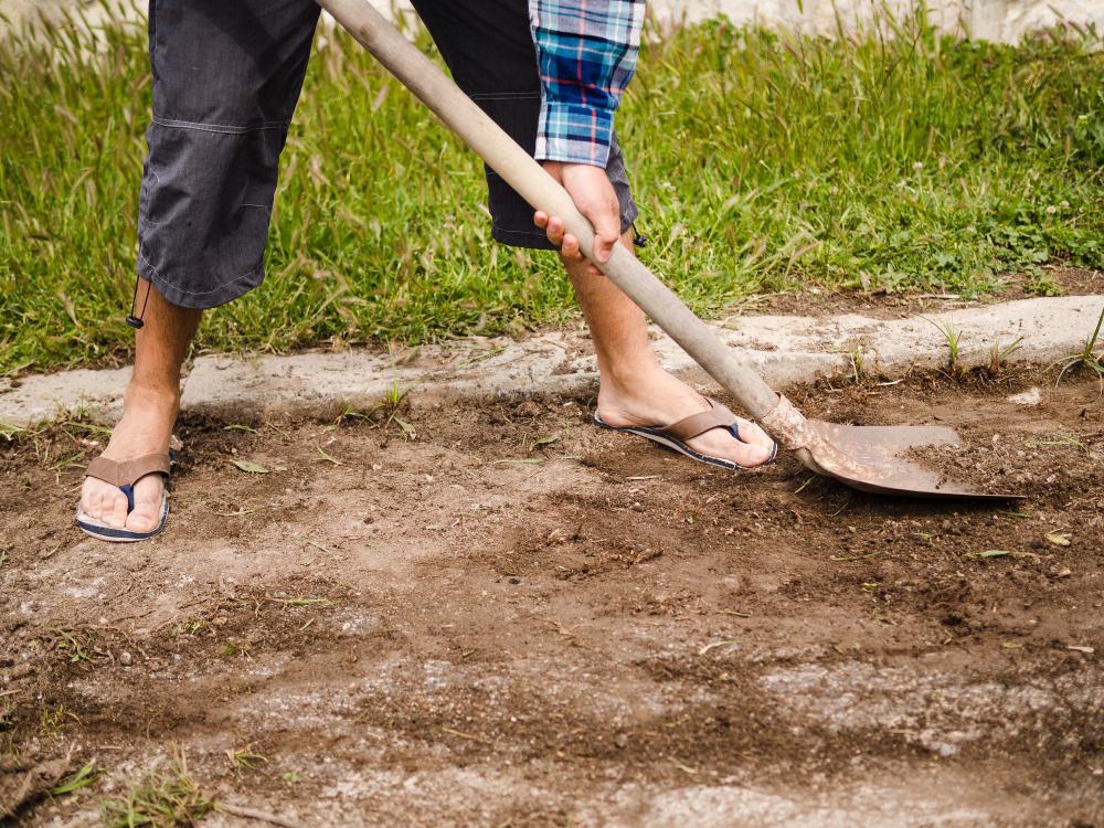 A photograph of a man digging at an archaeological site