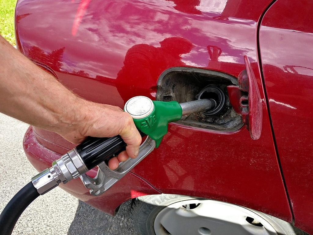 A man is pictured filling his car with gas