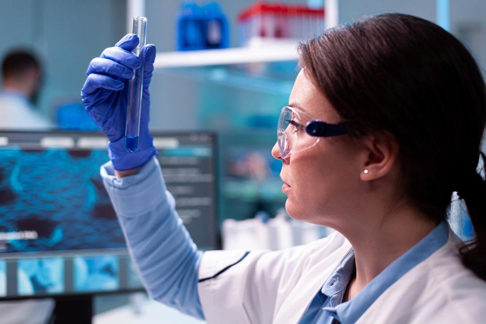 A photograph of a biologist checking the contents of a test tube